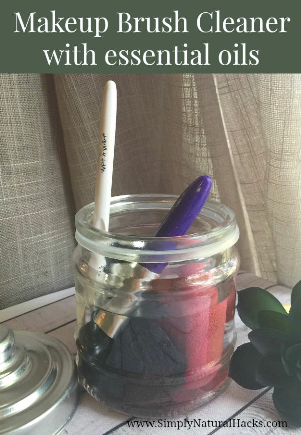 a jar of DIY makeup brush cleaner with makeup brushed soaking.
