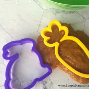 orange slime and Easter cookie cutters on white counter